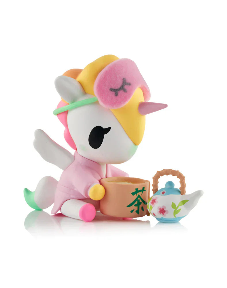 Enjoy pure kawaii wellness with the tokidoki Spa Day Unicorno Blind Box! Each pastel-colored figurine sports a pink sleep mask and robe, complete with floral teacup and teapot. Unbox a surprise collectible in every box!.