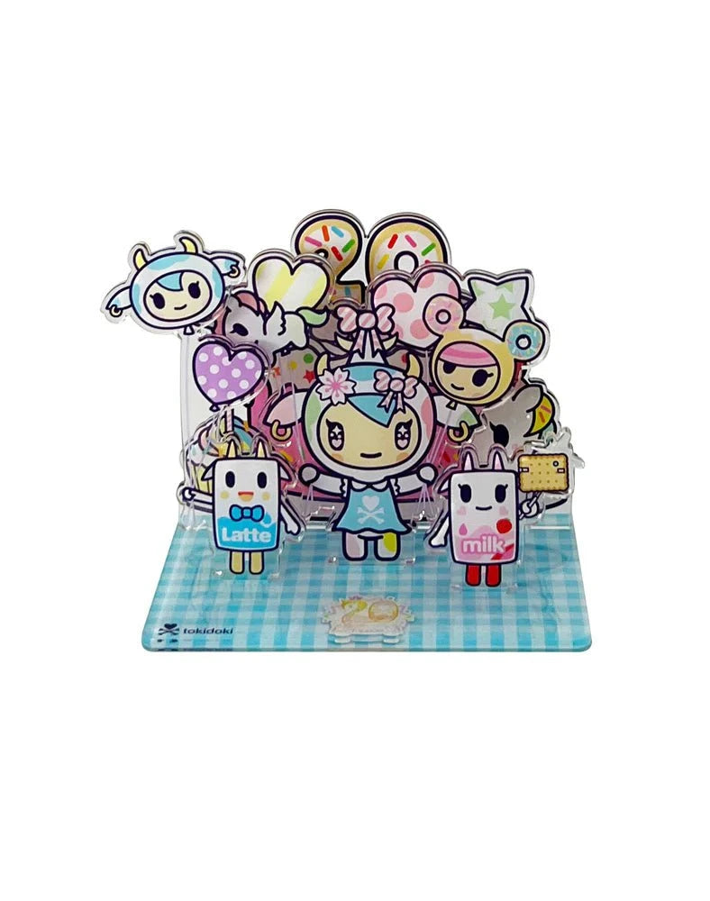 Celebrate tokidoki’s 20th Anniversary with this acrylic standee blind box featuring cute cartoon characters like a blue-haired girl, animal figures, and milk and latte cartons on a blue checkered base—a must-have for any tokidoki collection.
