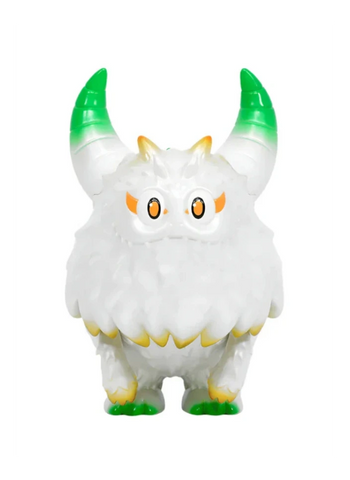The Little Hut’s Rangeas Rex Jr. — White & Gold is a fluffy collectible toy with two green-tipped horns, orange eyebrows, yellow claws, and wide eyes, shown standing against a plain background.