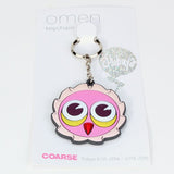 The Omen Shibuya Keychain by Coarse features a cartoon pink owl face with large eyes, attached to a card labeled 