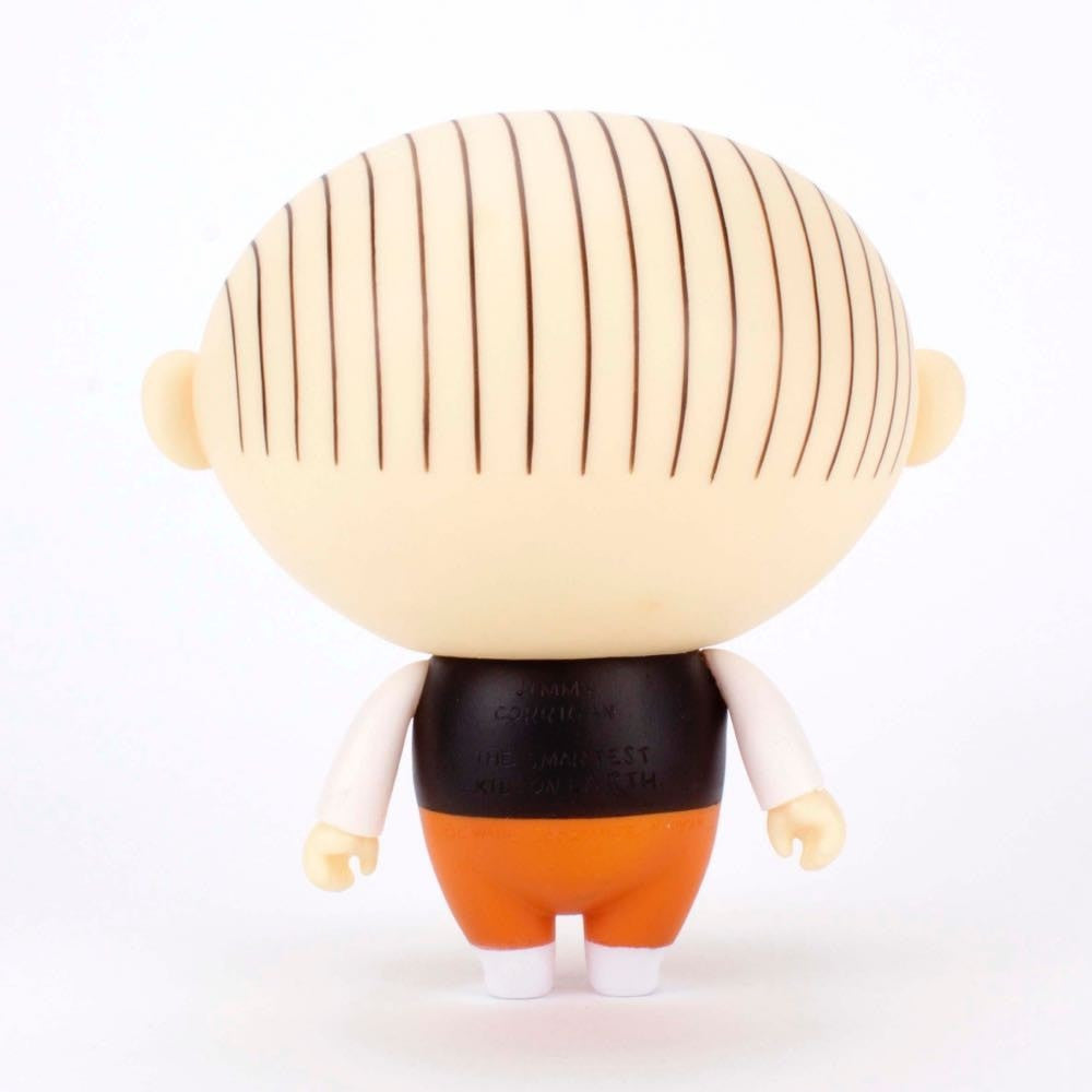 The Presspop Jimmy Corrigan Vital Animus Vinyl Doll is shown from the back, featuring a round head with vertical brown hair stripes, black shirt, orange pants, and white shoes against a white background.