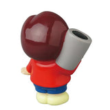 Medicom's Vinyl Artist Gacha Series 13 - Fumharu Kun: a collectible vinyl figure with a large maroon head, red shirt, blue pants, and yellow shoes, holding a gray cylinder over its shoulder and facing away from the camera.
