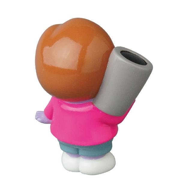 A Medicom Vinyl Artist Gacha Series 13 - Fumharu Kun figure with brown hair, pink shirt, blue shorts, and white shoes holds a large gray cylinder over its right shoulder. Viewed from behind.
