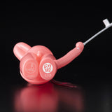 The Daily Flasher by mr. clement is a pink glow-in-the-dark balloon animal vinyl toy from Tomenosuke Shoten, shown on a black background with white Japanese text and a small graphic.