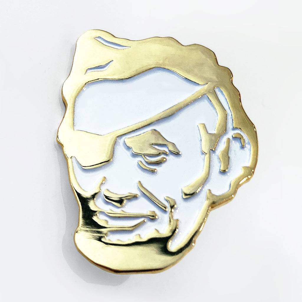 The Rotofugi Pirate Abe Enamel Pin by Rotofugi features a gold and white pirate face with stylized details—ideal as a mascot pin for designer toy shops or any enamel pin collection.