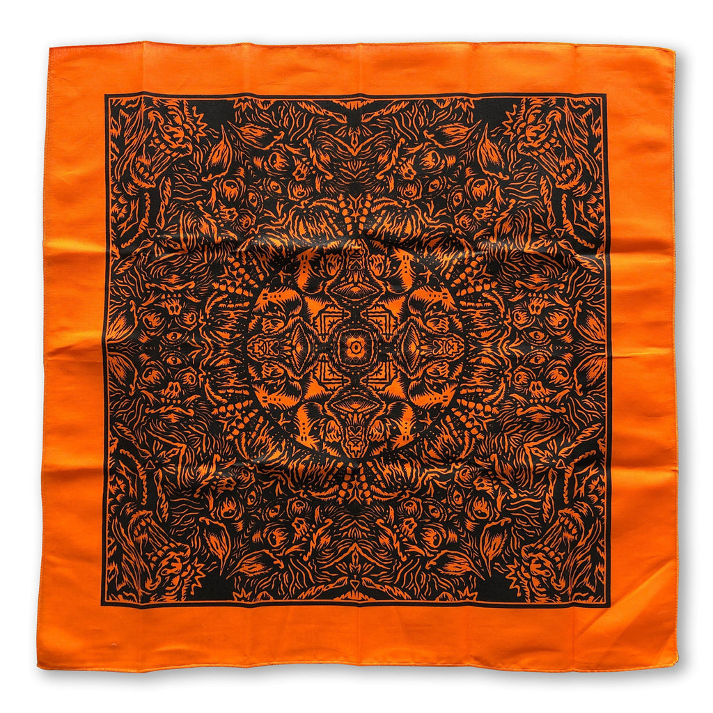 The Cherry Moth Cake Bandana by Cherry Moth Cake features an orange square with a black symmetrical design, detailed patterns, and shapes radiating from the center.