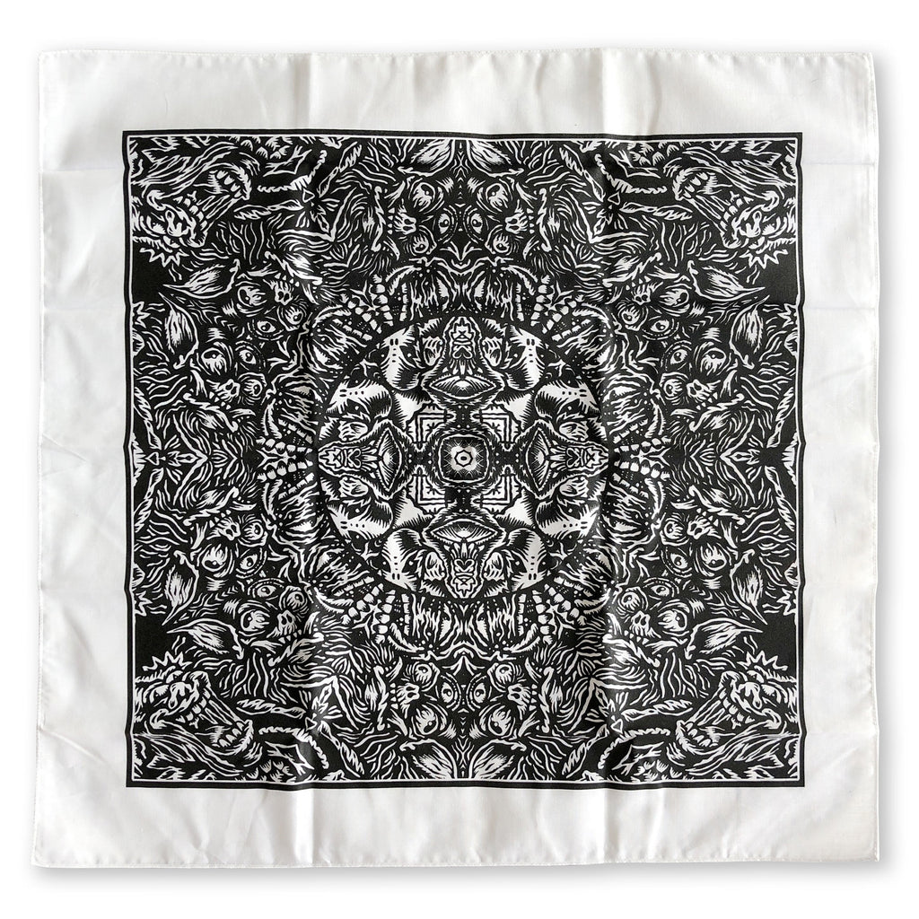 The Cherry Moth Cake Bandana by Cherry Moth Cake is a white square scarf with a detailed black symmetrical pattern featuring botanical and abstract elements in a mandala-inspired design.
