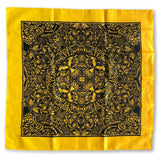 The Cherry Moth Cake Bandana by Cherry Moth Cake features a square yellow fabric with an intricate black symmetrical pattern of abstract shapes and organic motifs, framed with a bold black border.