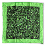 The Cherry Moth Cake Bandana by Cherry Moth Cake features a bright green color with a symmetrical, intricate black floral and organic pattern, shown flat on a white background.