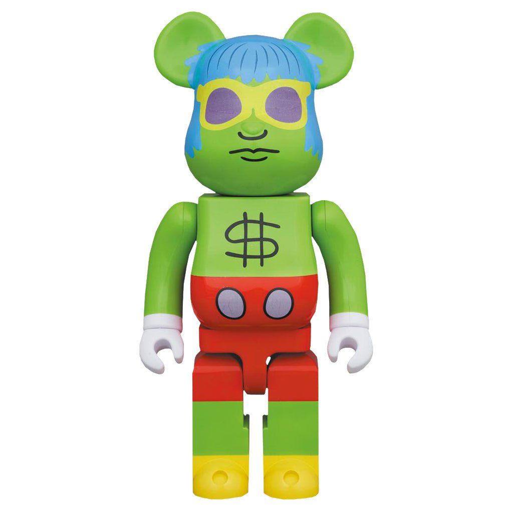 The Medicom Keith Haring — Andy Mouse 1000% Be@rbrick is a pop art collectible featuring a green face, blue hair, sunglasses, dollar sign chest, red shorts, and yellow feet, reflecting Keith Haring’s iconic playful style.