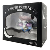 A Martian Toys Midnight Moon Bat — Bat Sabbatical w/ Free Print collectible is shown in black packaging with moon and star designs, plus a clear front window.