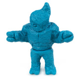 A small blue plastic figurine with a textured suit, large hands, and a pointed head—Neo-Fighters X Rotofugi 312 Edition by Geoff Maxfield—is a Rotofugi exclusive.